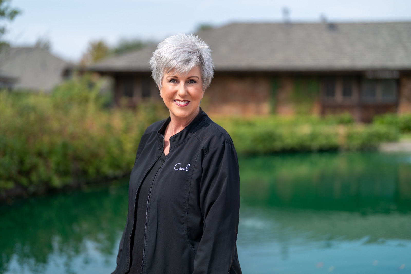 Carol from the Progressive Dental team smiling outside the office