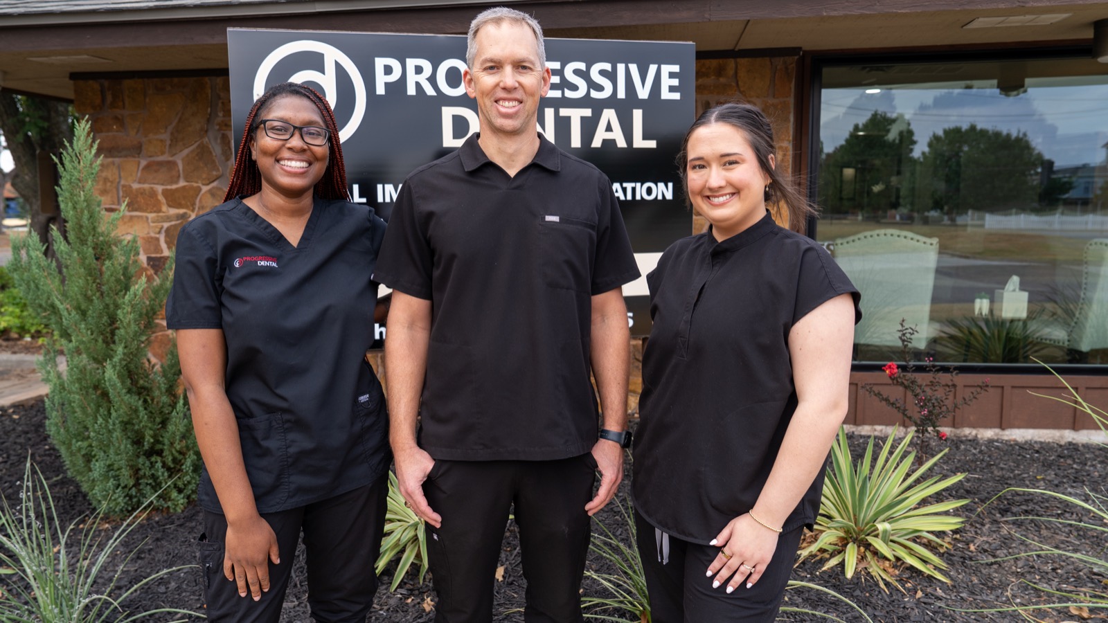Dr. Matthew McReynolds and team outside Progressive Dental